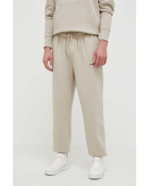 Calvin Klein Jeans spodnie dresowe kolor beżowy z aplikacją