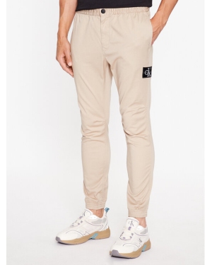 Calvin Klein Jeans Spodnie materiałowe Monologo J30J324045 Beżowy Slim Fit