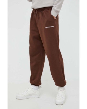 Calvin Klein Jeans spodnie dresowe kolor brązowy z aplikacją