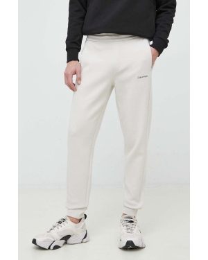 Calvin Klein spodnie dresowe męskie kolor beżowy gładkie