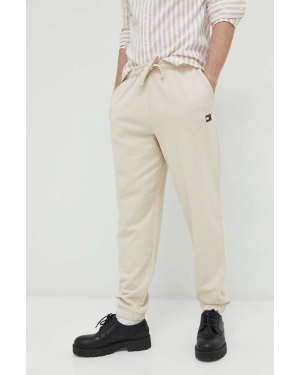 Tommy Jeans spodnie dresowe bawełniane męskie kolor beżowy gładkie